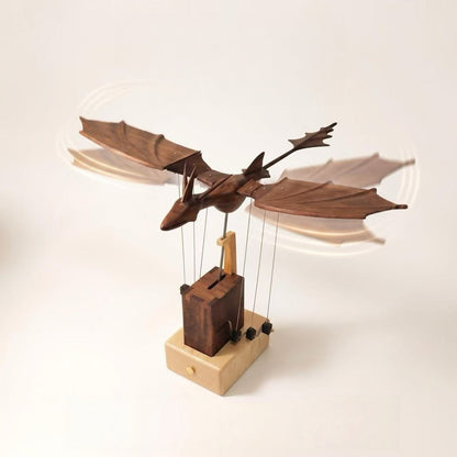 Side view of the handcrafted wooden dragon automaton with outstretched wings and a mechanical display base.
