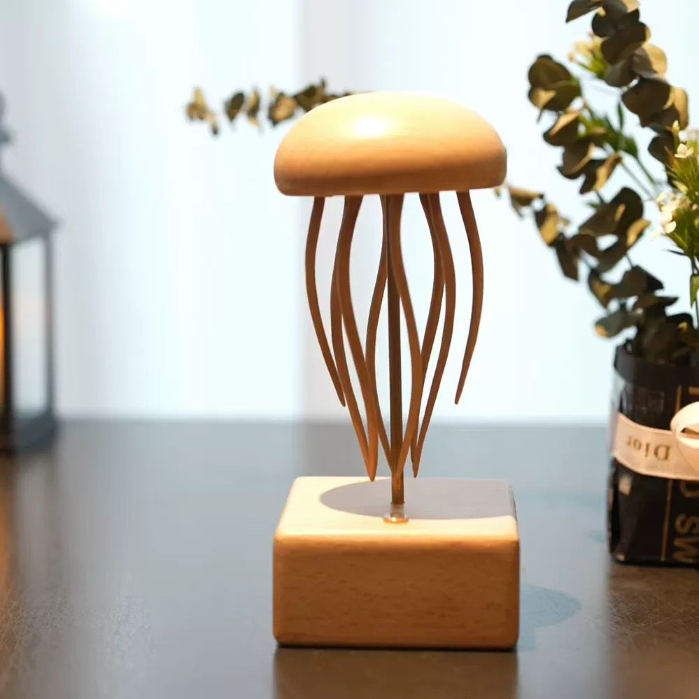 Wooden jellyfish kinetic art sculpture with delicate flowing tentacles, designed as unique desk and home decor.