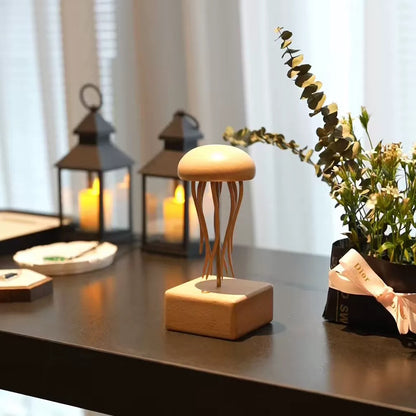 modern-home-decor.jpgHandcrafted wooden jellyfish sculpture displayed on a table with warm lanterns and flowers in a modern interior.