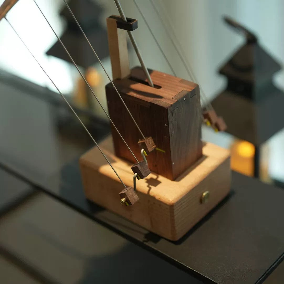 Close-up of the wooden mechanical base and suspension system of the manta ray automaton.