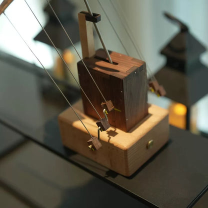 Close-up of the wooden mechanical base and suspension system of the manta ray automaton.